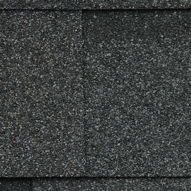 A close up of the asphalt shingles on a house