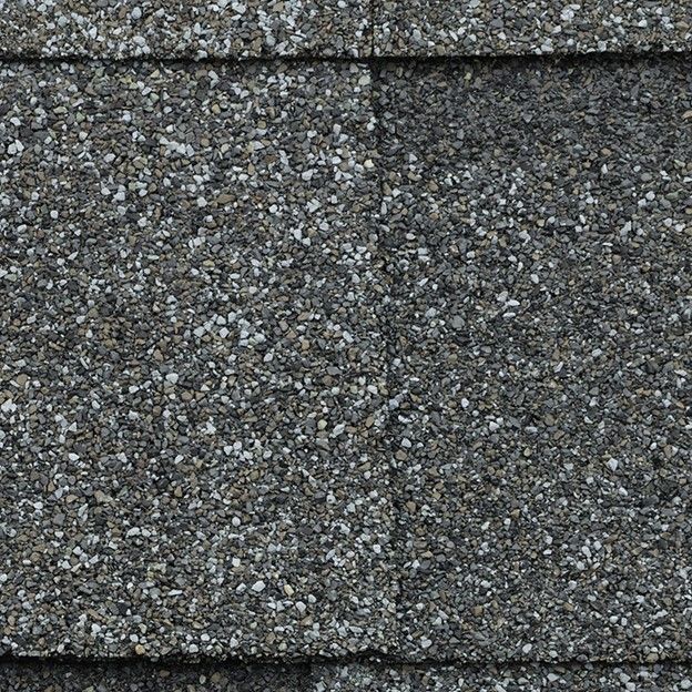 A close up of the asphalt shingles on a roof.