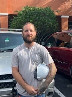 A man standing in front of some cars