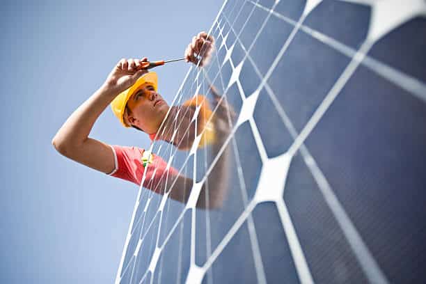 Male worker at work fixing solar panel Image of a man working with a photovoltaic panel (ISO 100). All my images have been processed in 16 Bits and transfer down to 8 before uploading. solar maintenance stock pictures, royalty-free photos & images