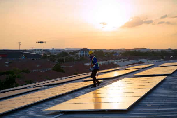 Blue collar workers are checking solar panel at roof top. solar panels save Blue collar workers are checking solar panel at roof top. Sustainable energy. Solar panel Absorption Of Sunlight stock pictures, royalty-free photos & images