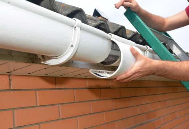 Roof gutter repair. Guttering repair. Roofer contractor repair house rain gutter pipeline. mall roof repair contractors install Roof gutter repair. Guttering repair. Roofer contractor repair house rain gutter pipeline. Gutter Repairs stock pictures, royalty-free photos & images